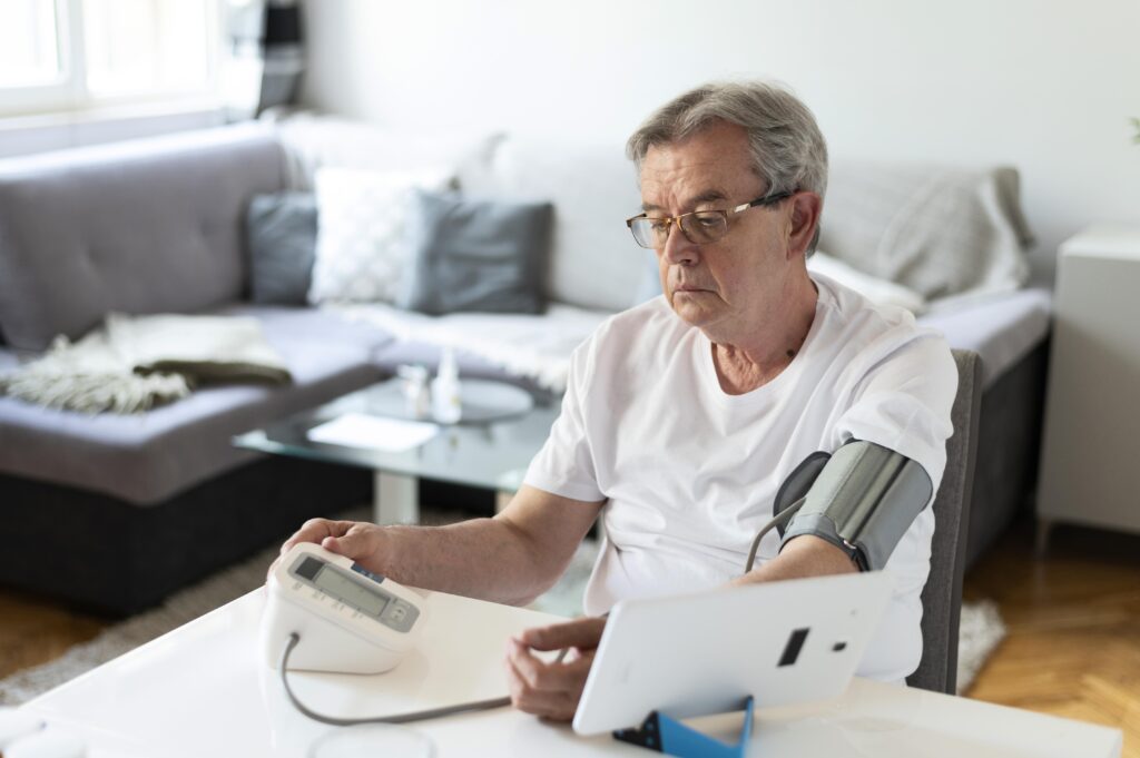 A person checking their blood pressure at home.