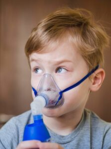 Child using an inhaler or struggling to breathe during physical activity