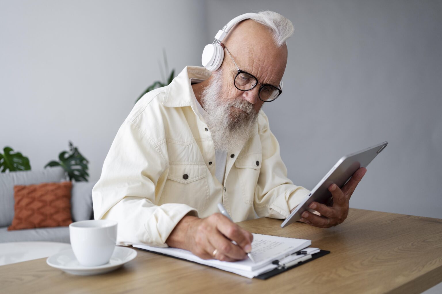 Elderly person doing a puzzle or using a tablet to learn.